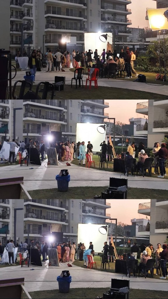 Behind the scenes of an outdoor film shoot with crew and lighting setups