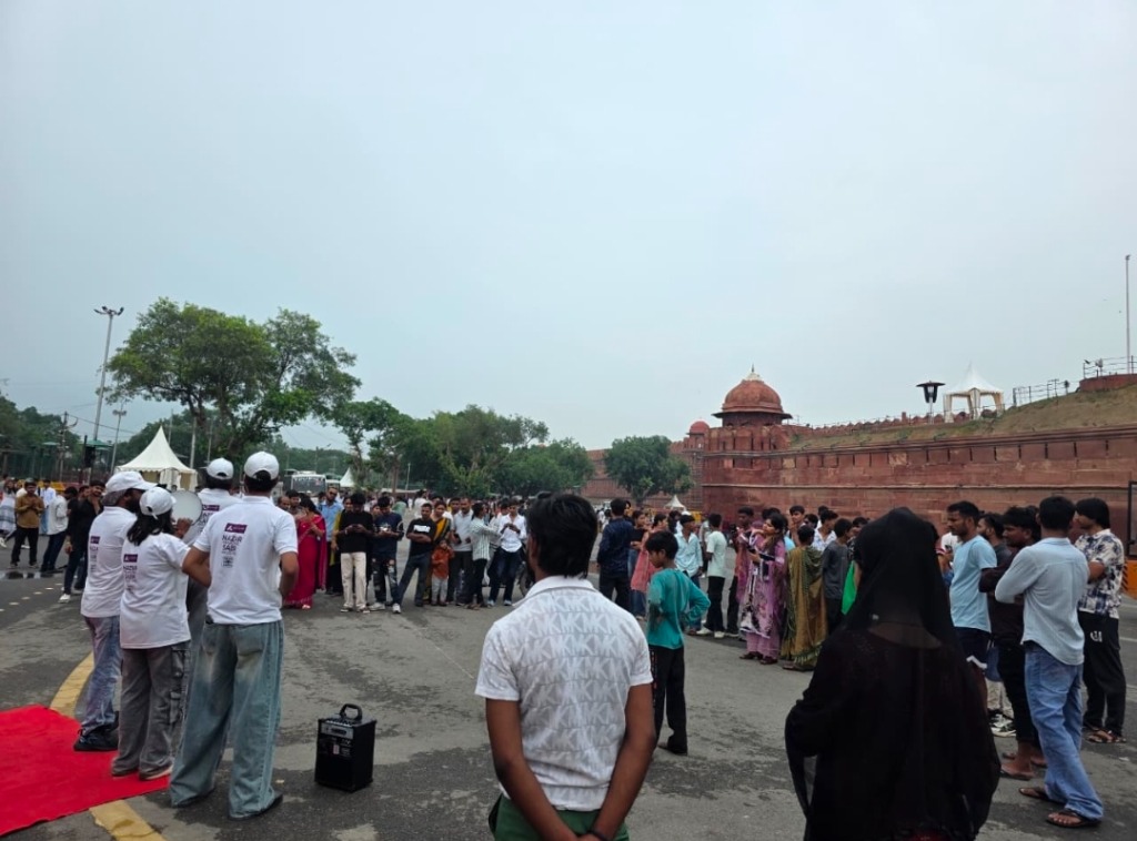 Street play performance in front of the historic Red Fort in Delhi with crowd